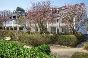 a large white house with trees and bushes at NeuKlosterhof App. 18 in Pelzerhaken