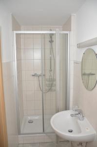 a bathroom with a shower and a sink at Hotel Sassor in Battenberg