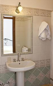 
a bathroom with a sink, mirror and bath tub at Villa Palumbo B&B in Positano
