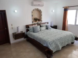 a bedroom with a bed and a window at Luxury apartment with ocean view at the beach in Cabarete