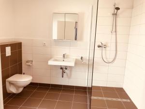 a bathroom with a toilet and a sink and a shower at Hotel Diele in Detmold +40 photos