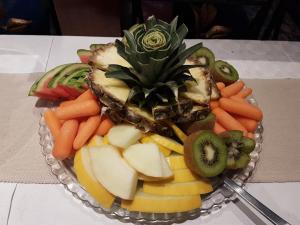 a plate of vegetables and fruit on a table at Senja Hotell in Finnsnes