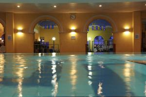 a large swimming pool in a building with arches at Hotel Irene in Bad König