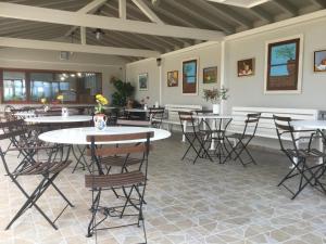 a room with tables and chairs with flowers on them at Ariadnes Holiday Accommodation II in Apidias Lakos