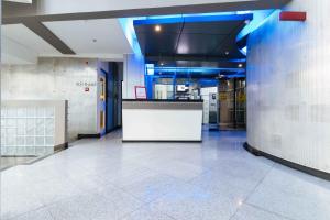 a lobby with a white counter in a building at RedDoorz Plus at Banawe Quezon City in Manila