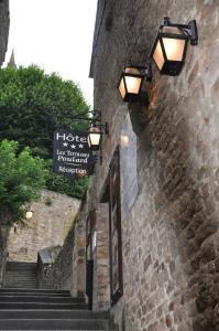 a stone building with lights on the side of it at Les Terrasses Poulard in Le Mont Saint Michel