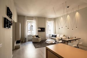 a living room with a couch and a table at Cinquanta4 Charme Apartment in Trento