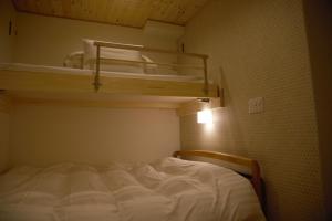 a bed in a small room with a bunk bed gmaxwell gmaxwell gmaxwell gmaxwell at Mountain Home Lodge in Deer Park in Nara