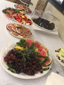 a table with several plates of food on it at Mcbest Guest House in Ermelo