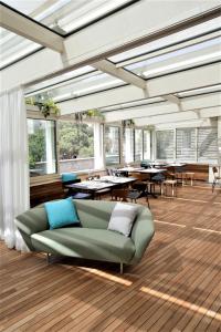 a living room with a couch and tables and windows at Grand Hotel Portovenere in Portovenere