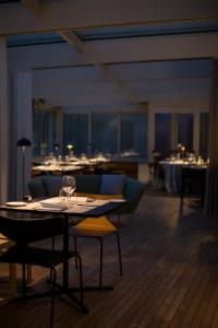 a dining room with a table with wine glasses on it at Grand Hotel Portovenere in Portovenere
