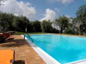 una gran piscina azul con árboles en el fondo en Agriturismo Il Vecchio Casale, en Vatolla