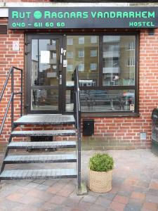 a store front with stairs in front of a building at Rut & Ragnars Vandrarhem in Malmö