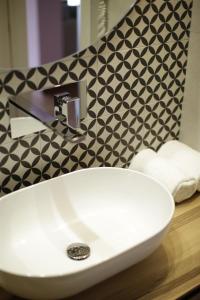 a bathroom with a sink and a black and white wall at Grand Hotel Portovenere in Portovenere