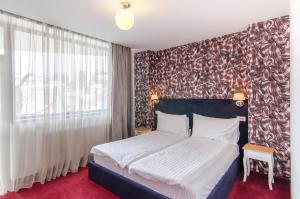 Postel nebo postele na pokoji v ubytování Apart Hotel Vlad Tepes