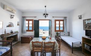 a living room with a table and a bedroom with a view at Villa Athina in Ambrami