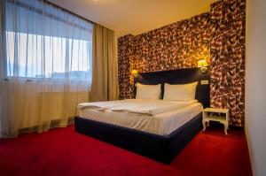 Postel nebo postele na pokoji v ubytování Apart Hotel Vlad Tepes