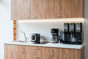 a kitchen with a counter with a coffee maker and a microwave at Theatre Boutique Apart-Hotel in Kyiv