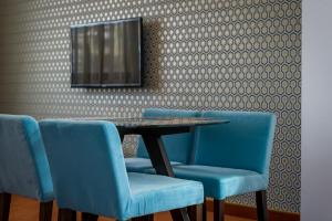 a dining room table and chairs in a room at Apart Hotel Vlad Tepes in Braşov