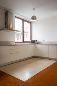 a kitchen with white cabinets and white appliances at Apart Hotel Vlad Tepes in Braşov