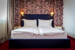 Postel nebo postele na pokoji v ubytování Apart Hotel Vlad Tepes