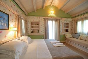 a bedroom with a large bed and a couch at Puppet rooms in Corfu