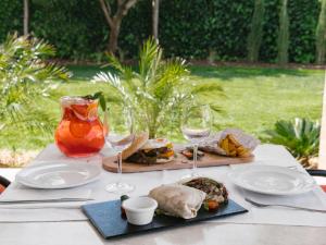 a table with wine glasses and food on it at Topazio Vibe Beach Hotel & Apartments - Adults Friendly in Albufeira