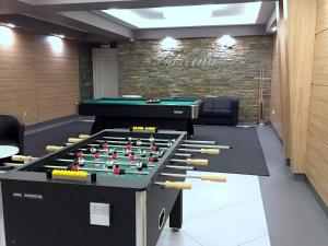 a conference room with a pool table and darts at Hotel Carlina in Białka Tatrzańska