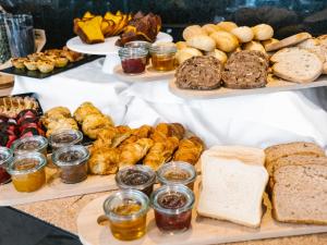 a buffet of different types of bread and pastries at Topazio Vibe Beach Hotel & Apartments - Adults Friendly in Albufeira