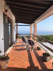 a patio with two chairs and a view of the ocean at Case del Tramonto in Ustica
