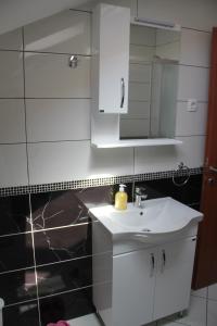 a bathroom with a white sink and a mirror at Apartments Dijana in Kotor +72 photos