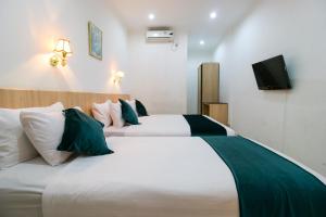 Postel nebo postele na pokoji v ubytování Mariani International Hotel
