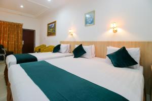 Postel nebo postele na pokoji v ubytování Mariani International Hotel