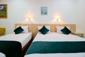 Postel nebo postele na pokoji v ubytování Mariani International Hotel
