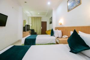 Postel nebo postele na pokoji v ubytování Mariani International Hotel