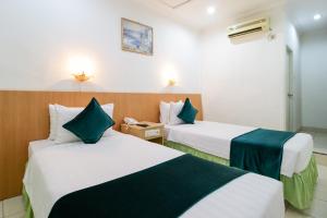 Postel nebo postele na pokoji v ubytování Mariani International Hotel