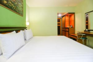 Postel nebo postele na pokoji v ubytování Mariani International Hotel