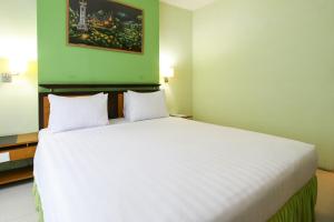 Postel nebo postele na pokoji v ubytování Mariani International Hotel
