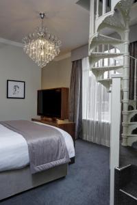 a bedroom with a spiral staircase and a bed at The Croft Hotel, BW Signature Collection in Darlington