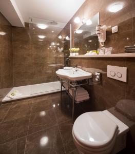 a bathroom with a toilet and a sink and a tub at Priska Heritage Rooms in Split