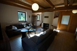 a living room with a couch and a fireplace at Stag house - Jeleni dom in Smižany
