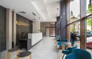 a lobby of a restaurant with blue chairs at Hotel Alexander in Krakow