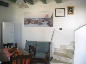 a dining room with a table and a chair and stairs at A casa di Lina in San Foca +17 photos