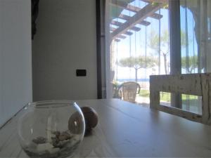 a glass vase sitting on top of a table at A casa di Lina in San Foca