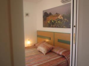 a bedroom with a bed and a painting on the wall at A casa di Lina in San Foca