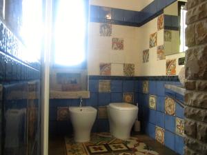 a bathroom with a toilet and a sink at A casa di Lina in San Foca