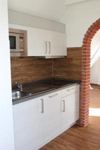 Kuchyň nebo kuchyňský kout v ubytování Hotel Fresena