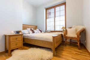 Postel nebo postele na pokoji v ubytování Apartamenty Tatrzańskie Turnie