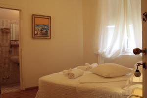 a bedroom with a bed with towels on it at Hotel Argentina in Santa Margherita Ligure