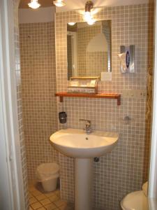 a bathroom with a sink and a mirror and a toilet at Hotel Argentina in Santa Margherita Ligure